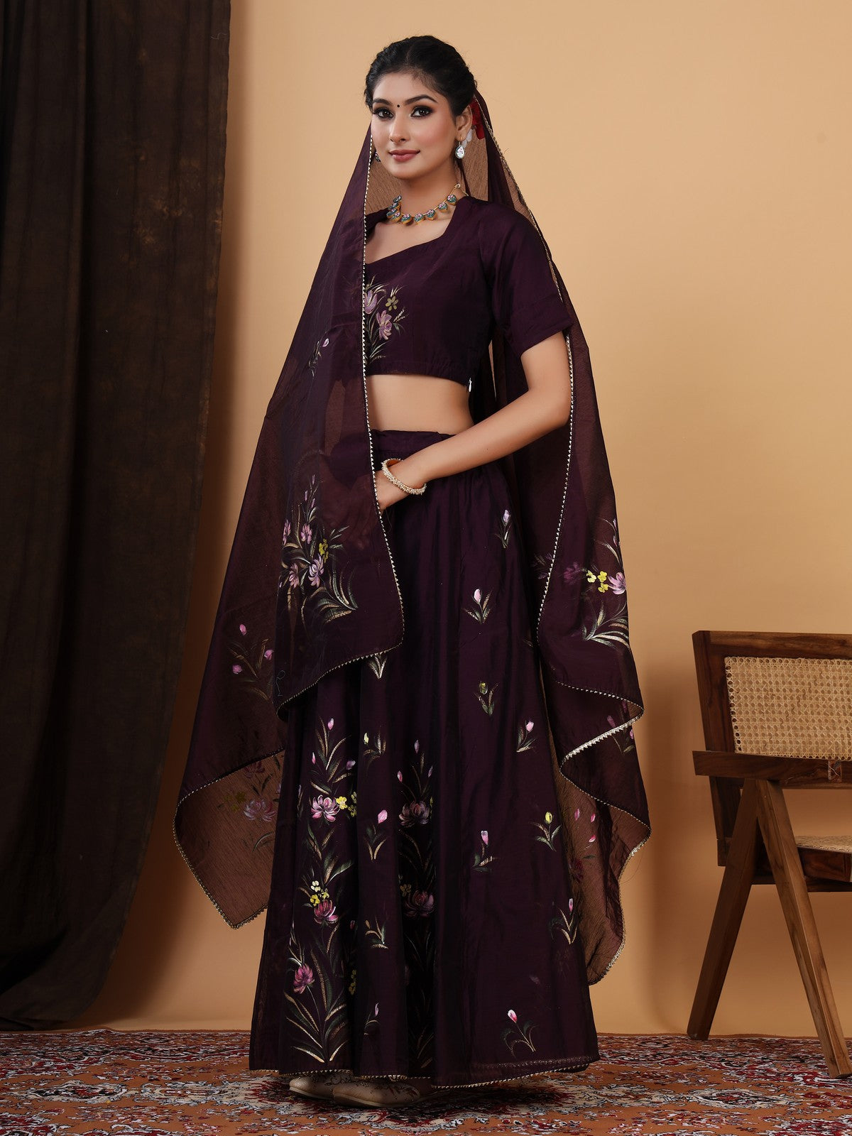 Crafted in a pretty wine color chanderi lehenga choli with Handpainted