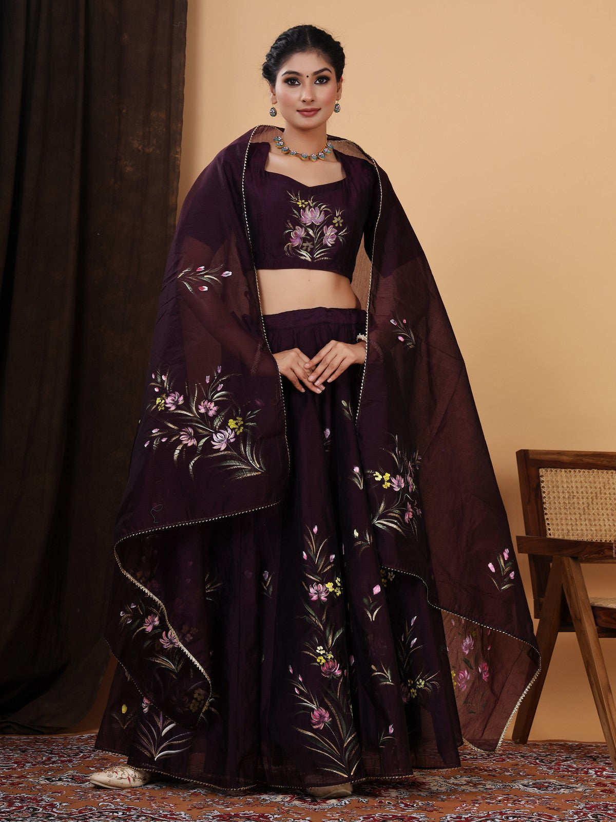 Crafted in a pretty wine color chanderi lehenga choli with Handpainted