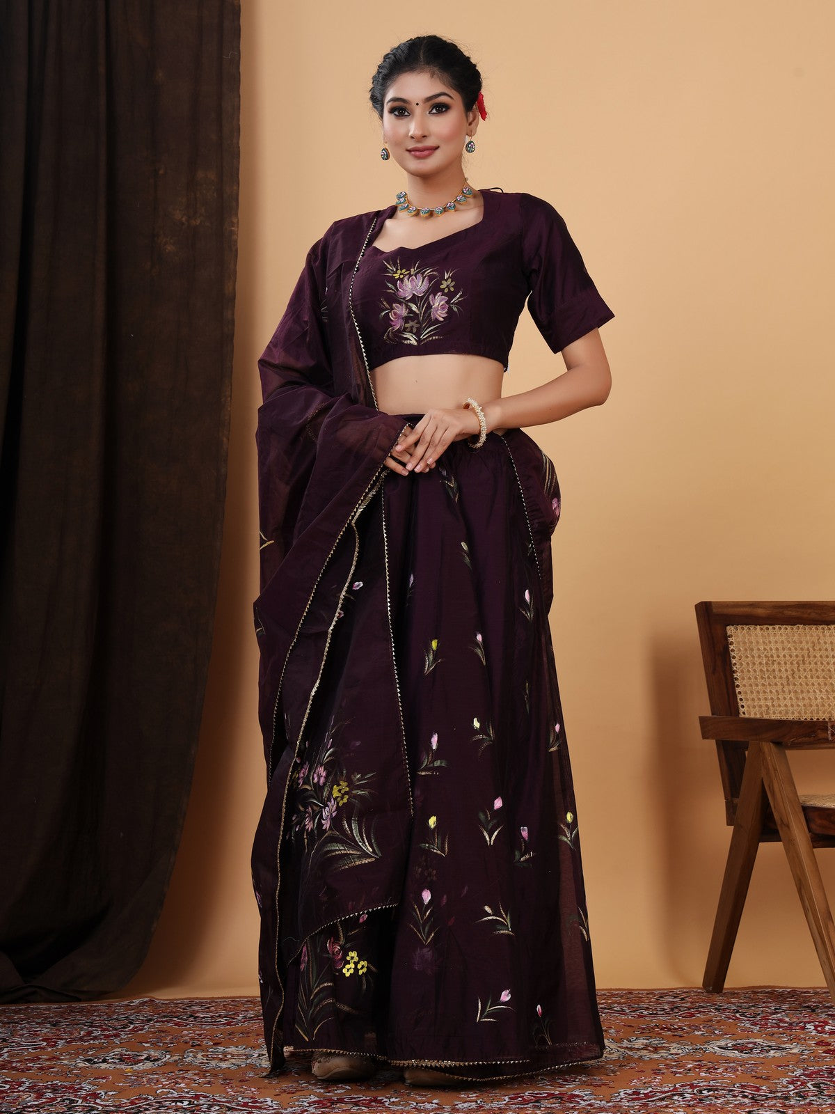 Crafted in a pretty wine color chanderi lehenga choli with Handpainted