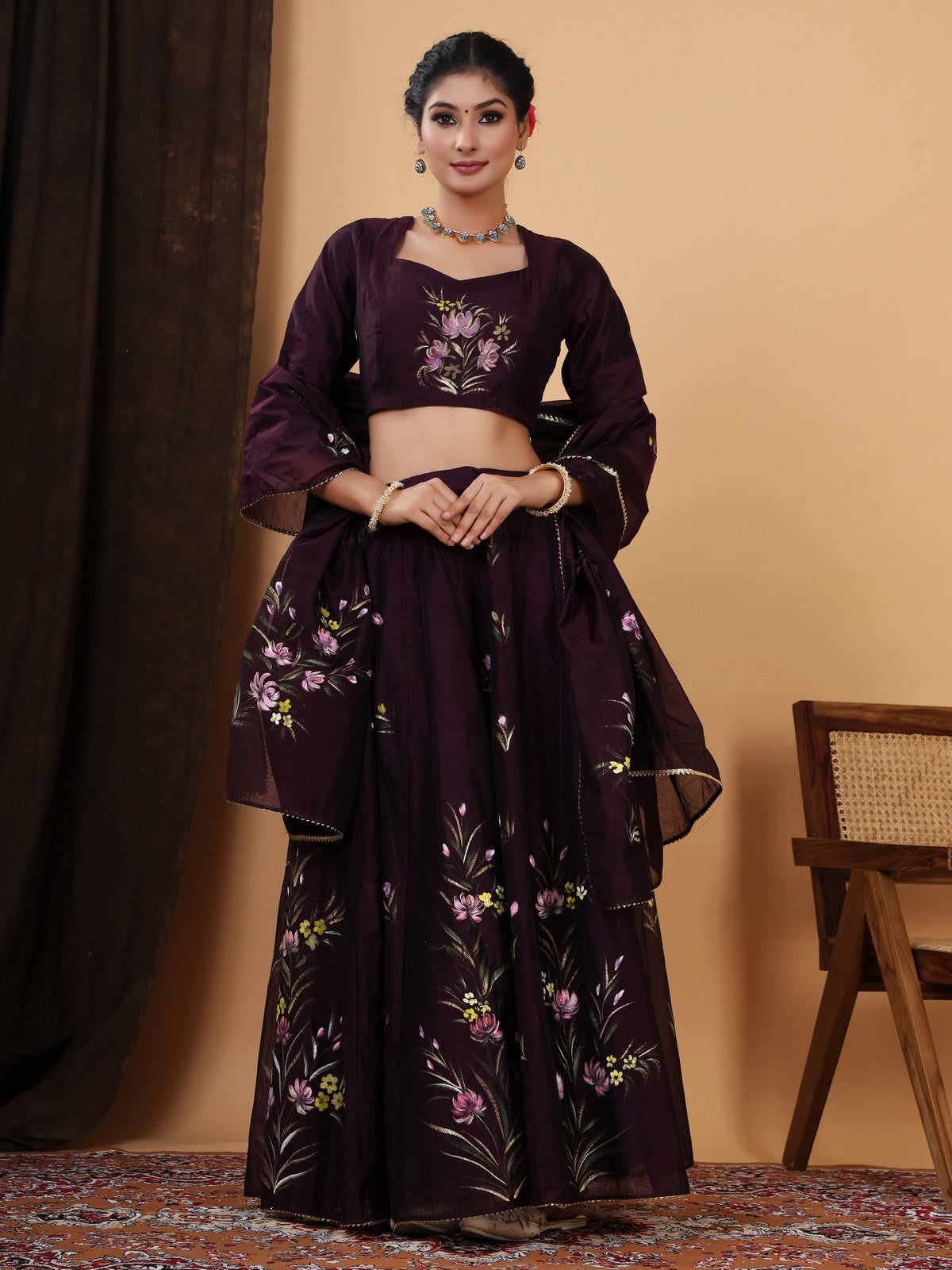 Crafted in a pretty wine color chanderi lehenga choli with Handpainted