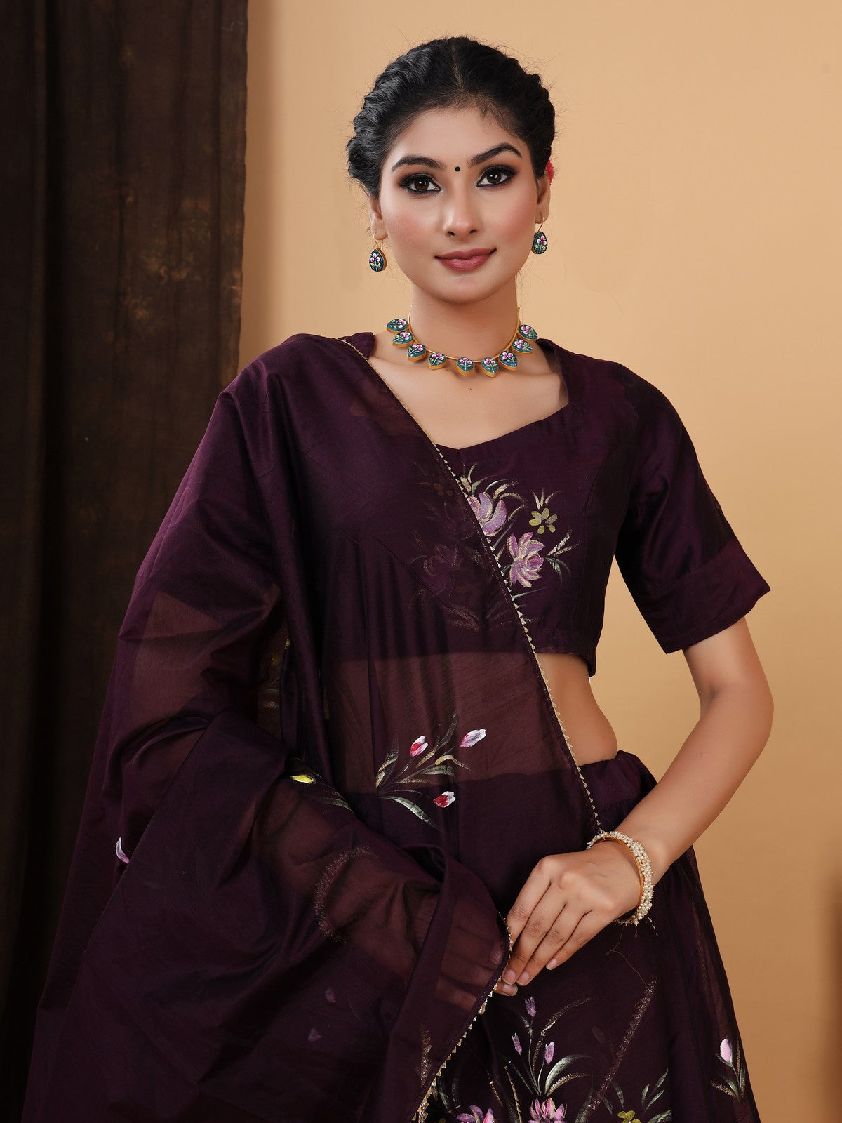 Crafted in a pretty wine color chanderi lehenga choli with Handpainted